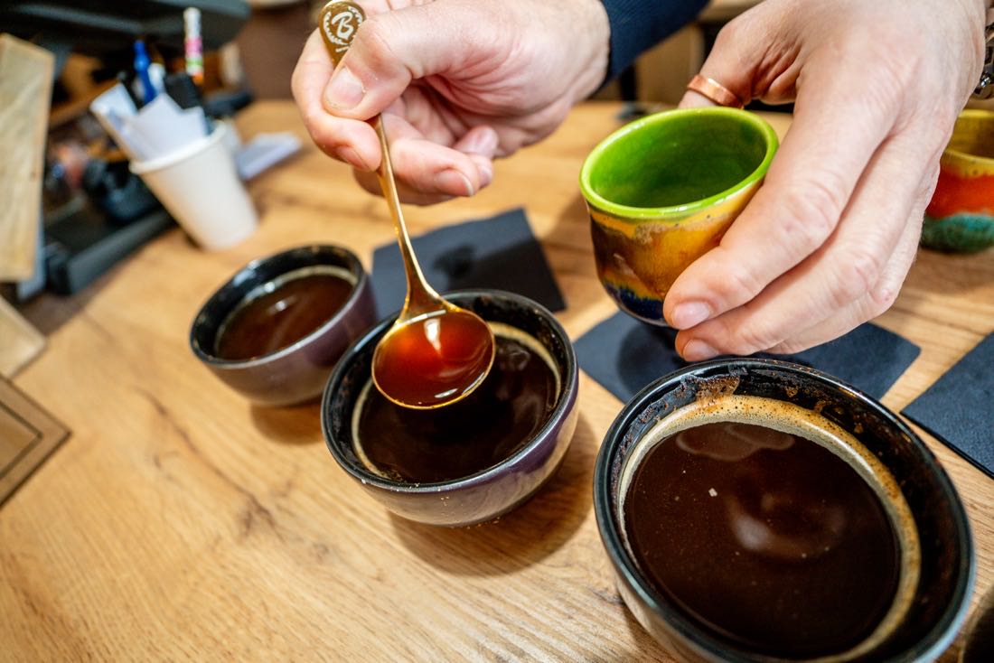 Degustacja porównawcza kawy w czarkach, łyżka nad filiżanką